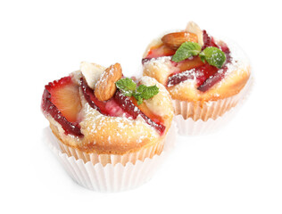 Delicious cupcakes with plums isolated on white
