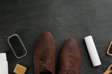 Stylish footwear with shoe care accessories on black table, flat lay. Space for text