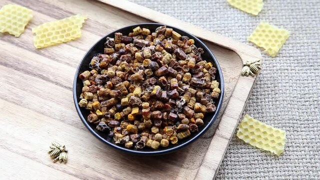 Alternative medicine  bee bread ( fermented flower and plant pollen by honey bees) pellets on plate.