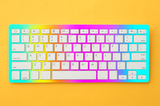Colorful computer keyboard on yellow background