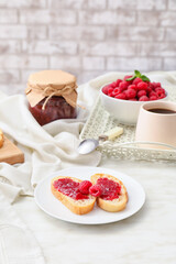 Composition with sweet raspberry jam on light background