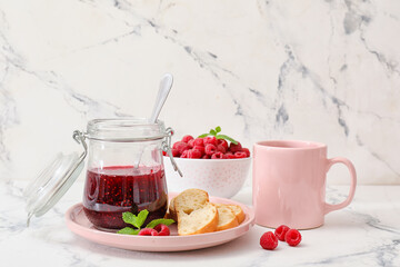 Composition with sweet raspberry jam on light background