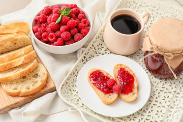 Composition with sweet raspberry jam on light background