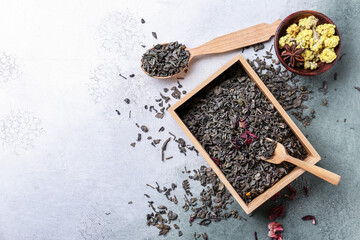 Composition with dry green tea on light background