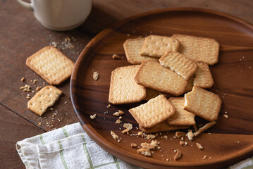 Homemade crackers stack on wooden plate for coffee break