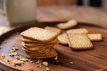 Fototapeta na wymiar Homemade crackers stack on wooden plate for coffee break