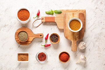 Bowls with different spices on light background