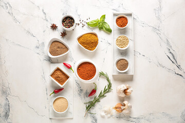 Bowls with different spices on light background