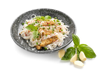 Plate with tasty noodles, chicken and garlic on white background