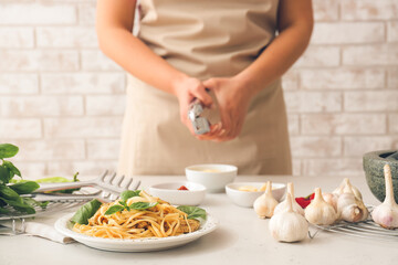 Plate with tasty noodles and chicken on table in kitchen