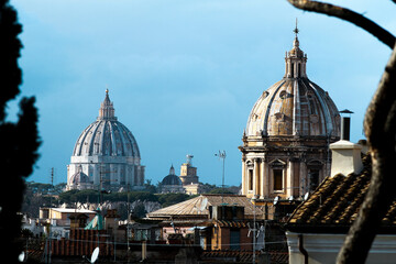 Fototapeta na wymiar Panorama of Rome, domes and roofs. On the left the dome of St. Peter's Basilica.