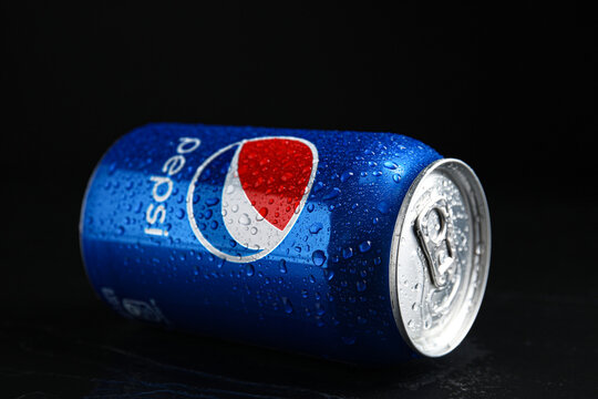 MYKOLAIV, UKRAINE - FEBRUARY 08, 2021: Can of Pepsi with water drops on black table, closeup