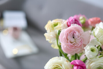 Bouquet of beautiful ranunculuses on blurred background. Space for text