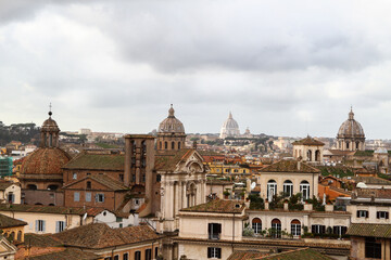 Fototapeta na wymiar Panorama over the roofs, churches and monuments of Rome, cloudy sky.