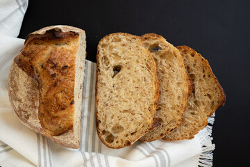 Fresh sliced ​​bread on a black background. View from above.