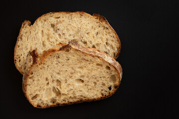 Fresh sliced ​​bread on a black background. View from above.