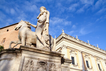 Fototapeta na wymiar Marble statue of Castor Dioscuri. The sculpture is located on Michelangelo Cordonata stairs and leading to Piazza del Campidoglio. Rome, Italy