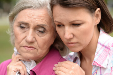 Sad Senior woman with adult daughter
