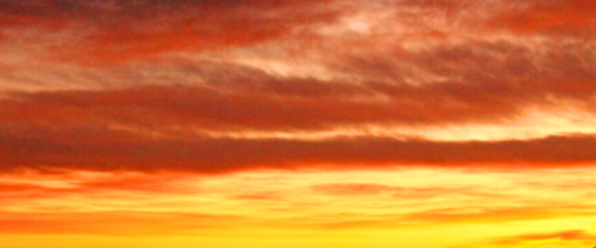 Colorful sky at sunrise time, bright orange and yellow colors background, wide