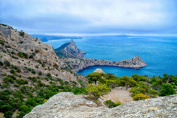 Mountains and sea are on background. Novyi Svit, Crimea, Sudak. Cape named Kapchik, sea is Black Sea. Beautiful landscape with views of the mountains, sea, forest.