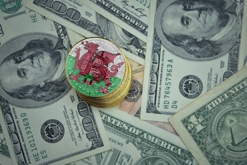 golden shining bitcoins with flag of wales on a dollar money background.