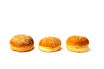 Three buns with sesame seeds isolated on a white