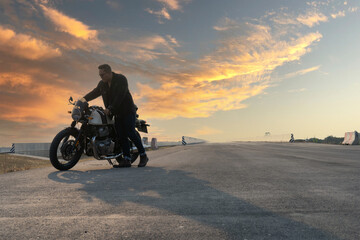 Portrait of biker and motorcyclist on the highway