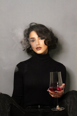 Beautiful young brunette model with bright make-up and curly hair