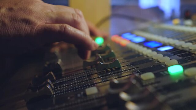 Man works on mixer in a club