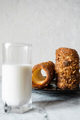 glass of milk and bakery with nuts and cinnamon. tdlo