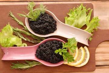 Black caviar with fresh herbs