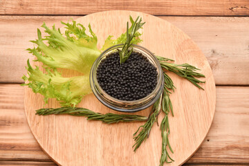 Black caviar with fresh herbs