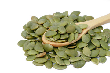 Raw pumpkin seeds on wood spoon organic food