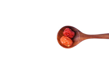 dried unabi fruit or jujube in wood spoon of  on white background. copy space for text.