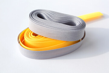 Yellow and gray oblique ribbons on a white background