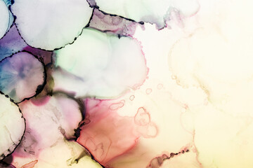 Abstract alcohol in background in pink, yellow, green and mauve tones.