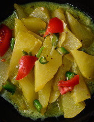 cooked chayote or chow chow in closeup, vegetarian dish on dark background, sri lankan vegetarian food