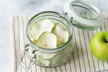full glass jar of dehydrated apple chips. Vegan dessert concept. top view. close-up