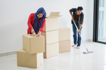 Portrait of young muslim couple preparing for moving to new house