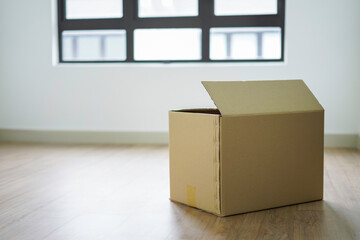 Box on empty room as moving to new house concept