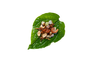 Miang Kham Small pieces of garnish are arranged on basil leaves. Contains ginger, lime, roasted coconut, onions, dried shrimp and peanut lad with sweet and mellow syrup. Isolated white background. 