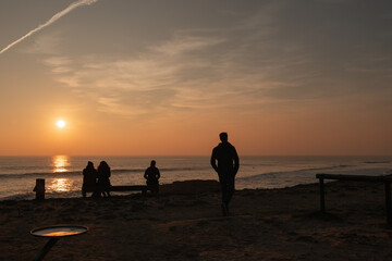 Man walking at sunset in the Atlantic ocean in Portugal