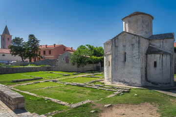 Fototapeta na wymiar Old, dated on 9th century, Church of the Holy Cross in early Romanesque architecture, located in old district of Nin town on small island, Croatia