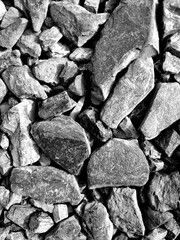 texture of large stony rubble in different shades of gray, top view close to the background. abstract close up of stones of different sizes and shapes gray color top view