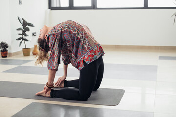 Fit young woman practice yoga. Fitness female instructor doing yoga meditation indoors.
