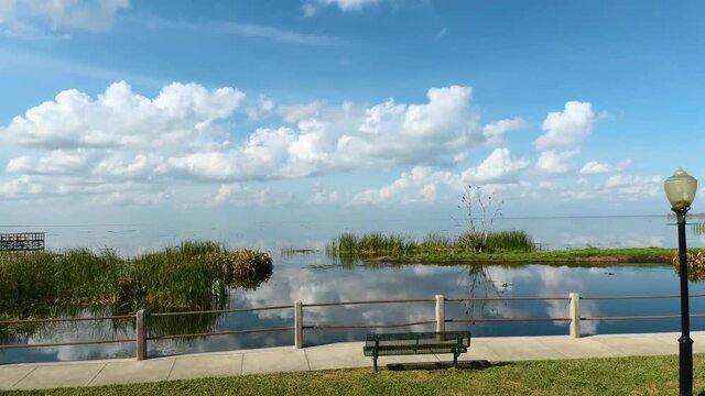 Brilliant blue sky and clouds reflect on Lake Apopka at Winter Garden Florida