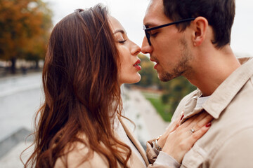 Portrait of couple in love   embarrassing and staying face to face in autumn  park.