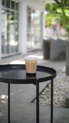 Ice coffee with plastic cup at outdoor cafe , East Java