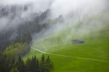 South Tyrol impressions with a mountain hut in the fog.