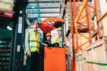 Working Team at warehouse. Manager man and asian woman warehouse worker standing to look at the...